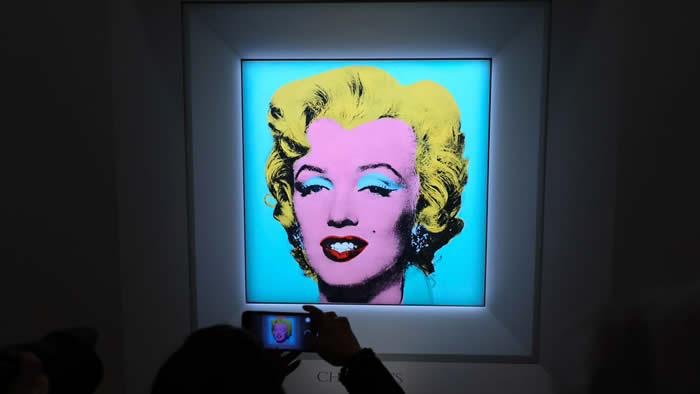 NEW YORK, NEW YORK - MARCH 21: A guest takes a photo during Christie's announcement that they will offer Andy Warhol's Shot Sage Blue Marilyn painting of Marilyn Monroe at Christie's on March 21, 2022 in New York City. The work comes to Christie's from the Thomas and Doris Ammann Foundation Zurich and all proceeds of the sale will benefit the foundation. (Photo by Dia Dipasupil/Getty Images)